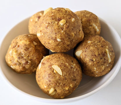 Assorted Healthy Snacks Pack – A selection of nutritious dry fruit laddoos and roasted nuts for a wholesome snacking experience.